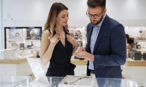 A woman and man browse jewelry in a store